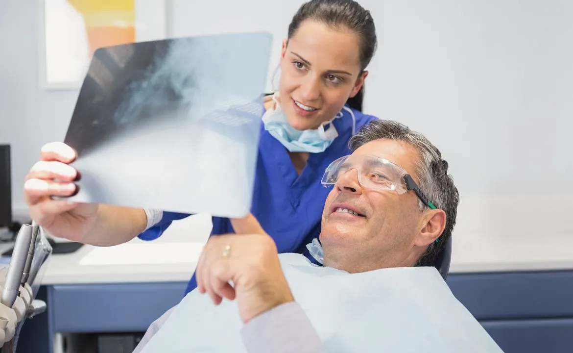 Dental team member reviewing an x-ray with a patient